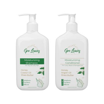 Two pump bottles, one labeled for moisturizing shampoo with honey and castor oil, and the other for moisturizing conditioner with Moroccan Argan oil and shea butter.